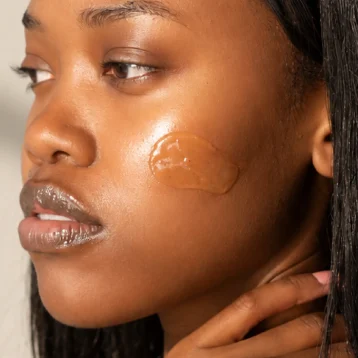 Woman wearing Seabody Hydrogel Mask Cleanser on her cheek