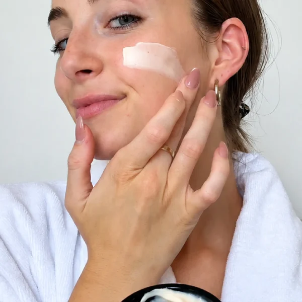 Girl using Seabody Glycan Enrich Moisturiser on her face