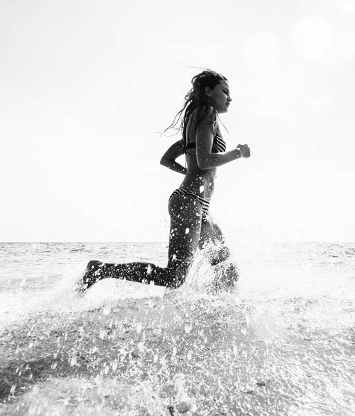 black and white girl running in the sea